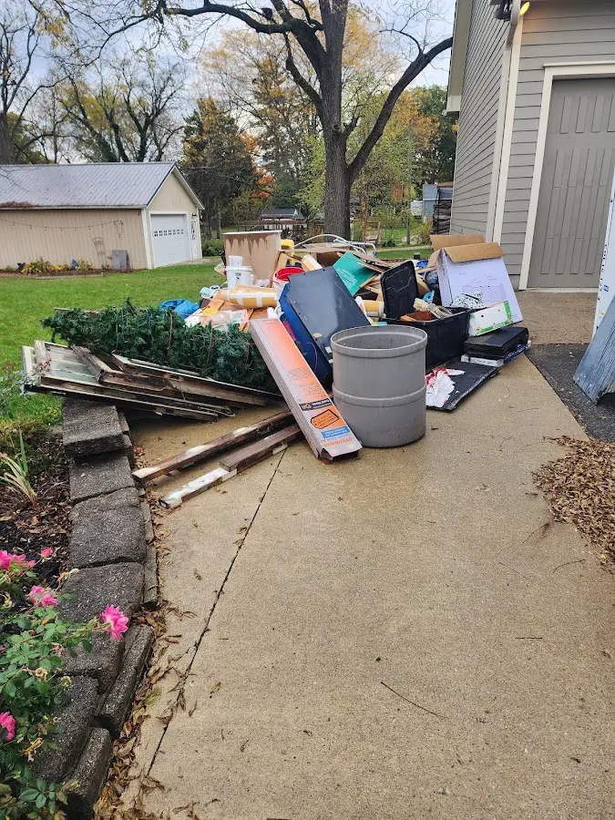 Dumpster being loaded with debris for Residential Dumpster Rental in Little Canada